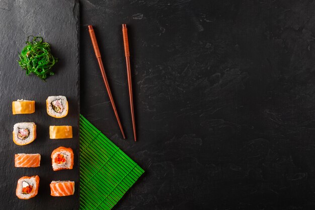 Set of sushi and maki on stone table. top view with copy space