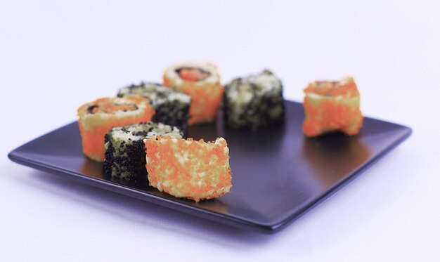 Set of sushi rolls on black plate