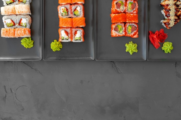 Set of sushi rolls served on gray background