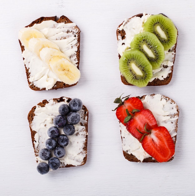 Set sweet sandwiches with cream-cheese and fresh berries and fruit 