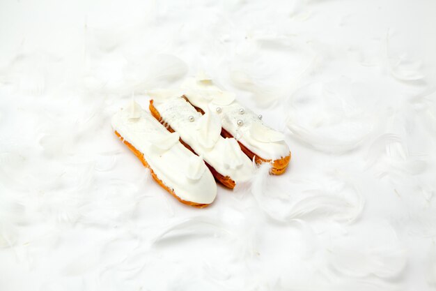 A set of three eclairs with white chocolate decorarion