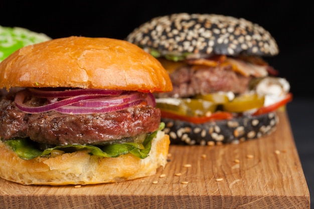 Photo set of three mini homemade burger.