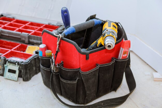 Set of tools in a bag on wooden background