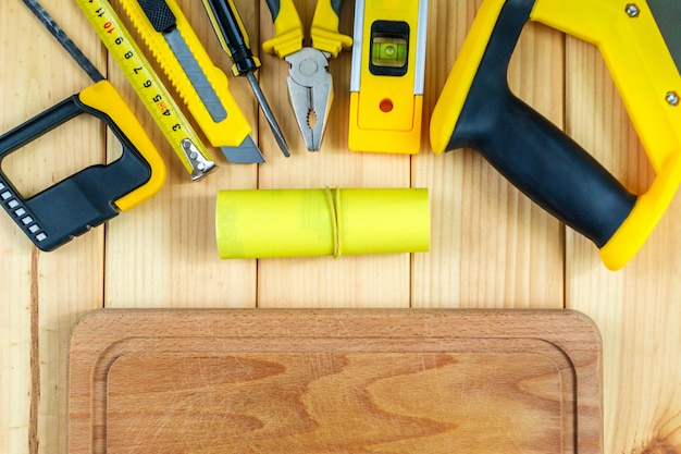 Set of tools for the Builder on a wooden background with a place for advertising.