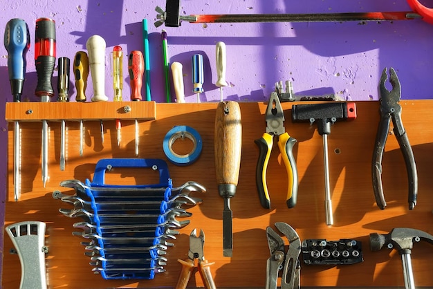 A set of tools carpenter or locksmith hanging on the wall Background