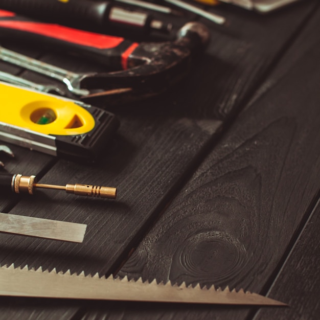 A set of tools laid out in a semicircle on top of the wooden table with copy space