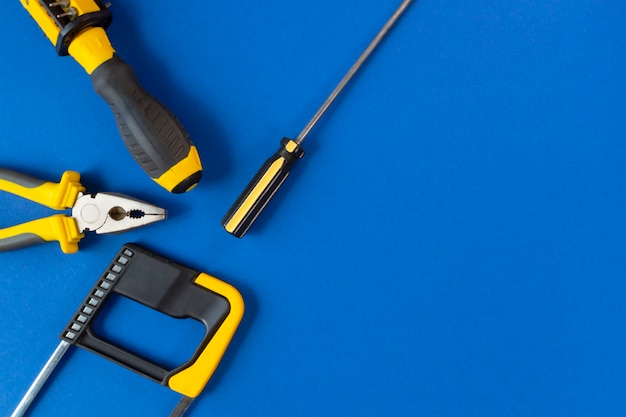 A set of tools for repair isolated on a blue wall