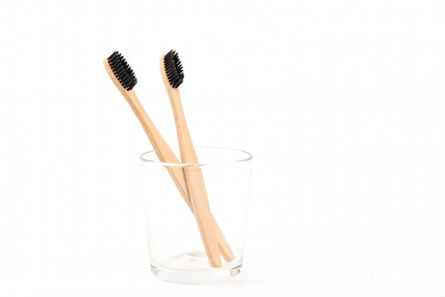 Set of toothbrushes in glass isolated on white background. Bamboo eco-friendly. Zero waste