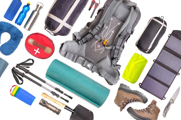 Set of tourist trekking items on white background Top view of accessories for travel