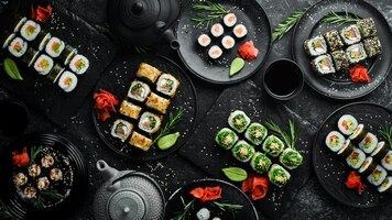 Set of traditional sushi on a black plate sushi and rolls on a dark background