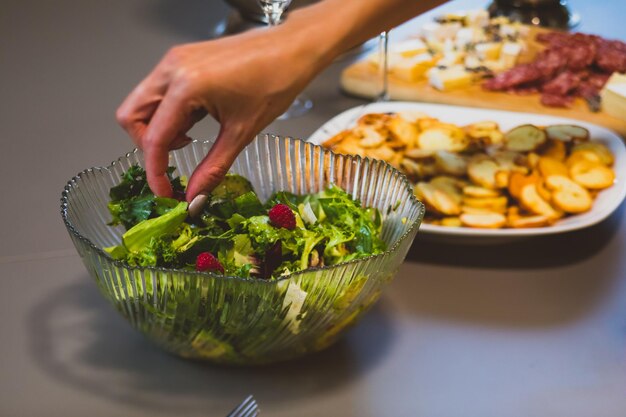 Set up table with salad and boards of appetizers