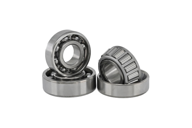 Set of various ball and roller bearings on white background