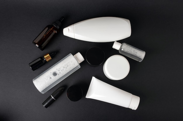 Photo set of various body cosmetics on a black background top view