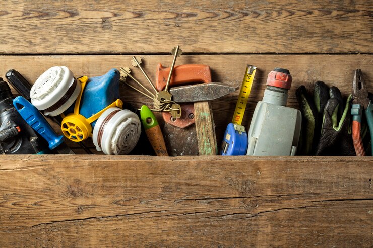 Photo set of various old handmade tools on wooden background top view
