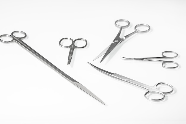 Set of various scissors for a hairdresser on a light background