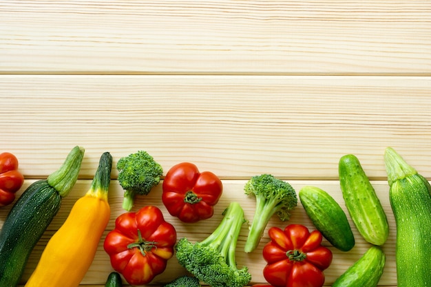 Set of various vegetables on a light wooden background. Space for text.