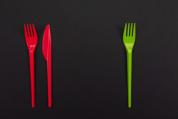 Set of vibrant forks and knife isolated on black