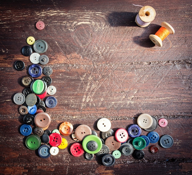 Set of vintage buttons on old wooden table