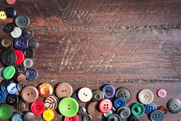 Set of vintage buttons on old wooden table