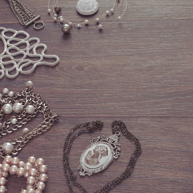 Set of vintage jewelry on a dark wooden background.