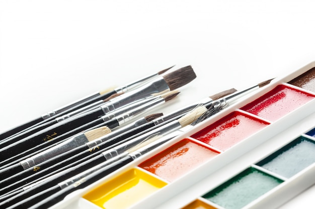 Set of watercolor paints and paintbrushes