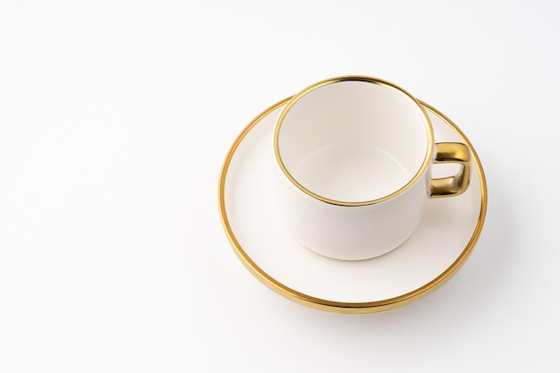 A set of white and brown ceramic plate and cup on a white background