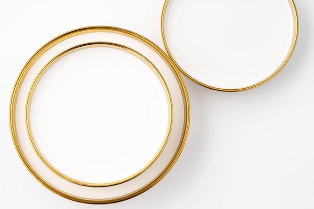 A set of white and brown ceramic plates on a white background Top view