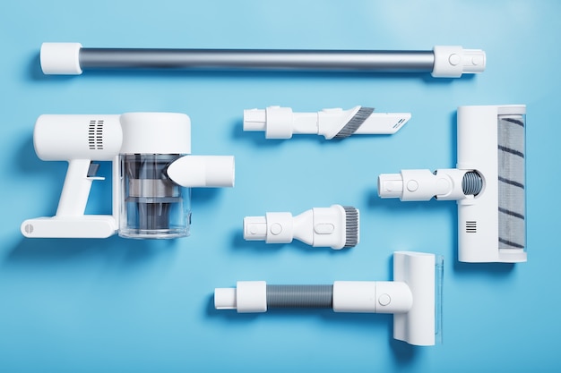 파란색 배경에 무선 현대식 진공 청소기와 노즐 세트