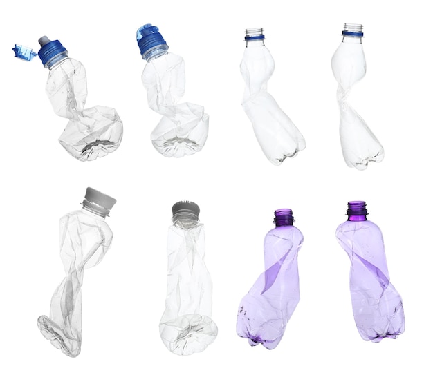 Set with empty crumpled bottles on white background