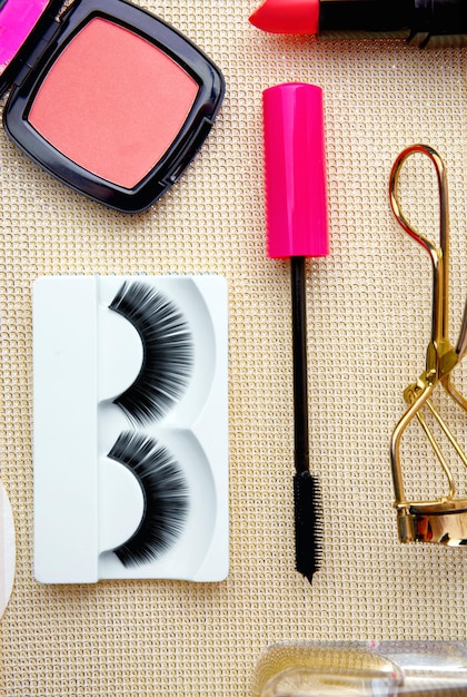 Photo set with false eyelashes on light background