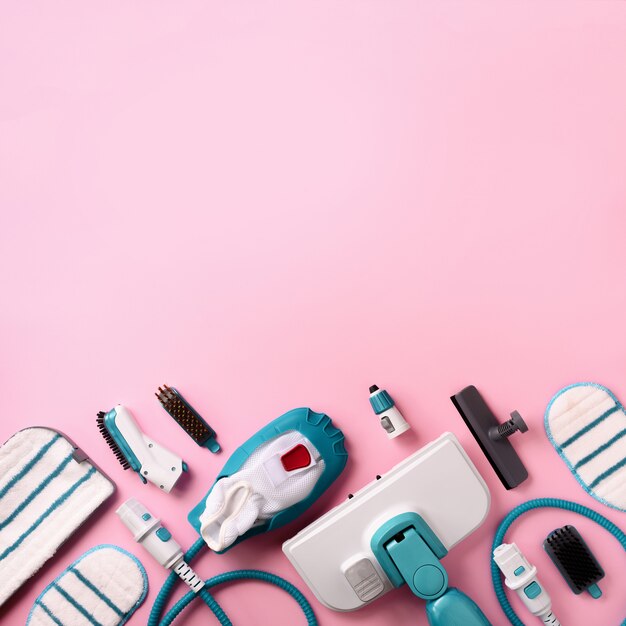 set with modern professional steam cleaners on pink background.