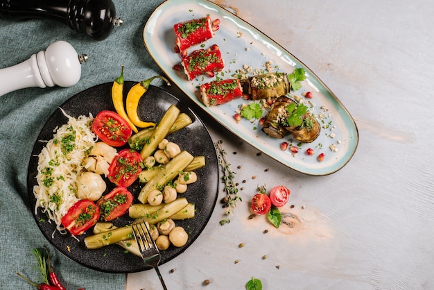 Set with tomatoes, cabbage, mushrooms, cucumbers on the wooden background