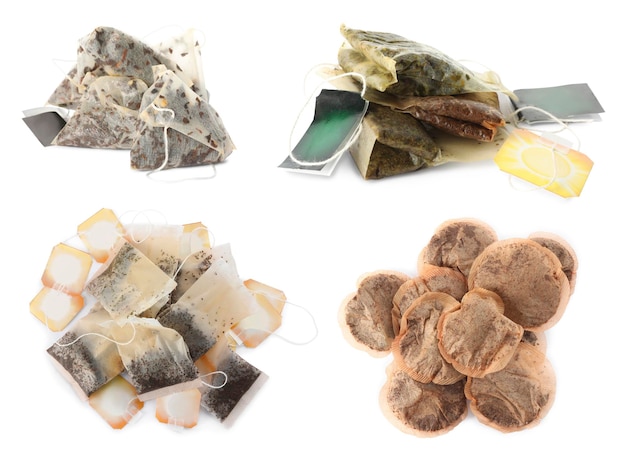 Set with used tea bags on white background