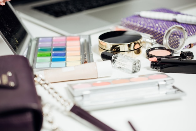 Set of women's cosmetics on table. Eyeshadow and lipstick