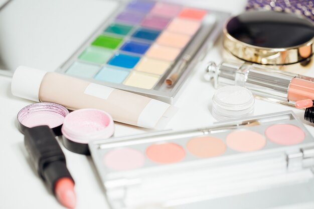 Set of women's cosmetics on table. Eyeshadow and lipstick