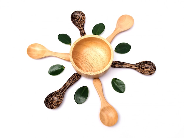 Set of wooden bowl and vintage spoon or teaspoon with green leaf.