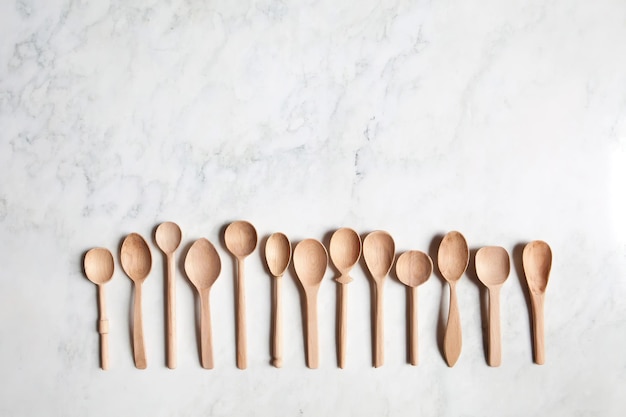 Set of wooden handicraft spoons on the table top view