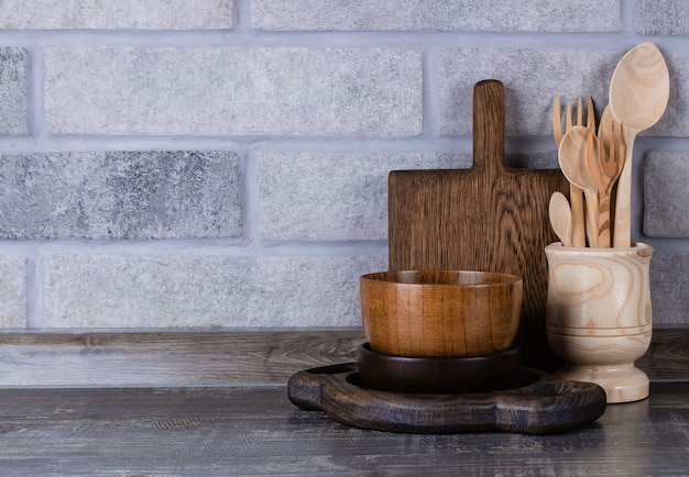 Set of wooden kitchen utensils on the kitchen table. Copy space