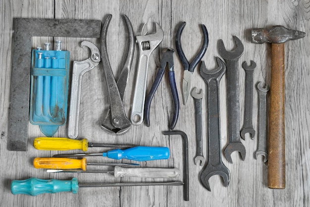 Set of work hand tools on grey wood background