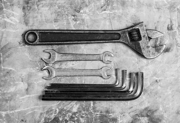 Photo set of wrench on gray concrete background. work tool. top view