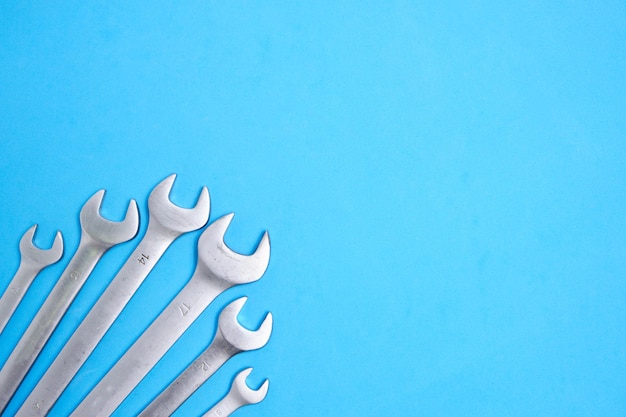 Set of wrenches on a blue background.