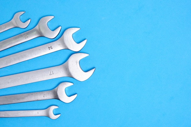 Set of wrenches on a blue background.