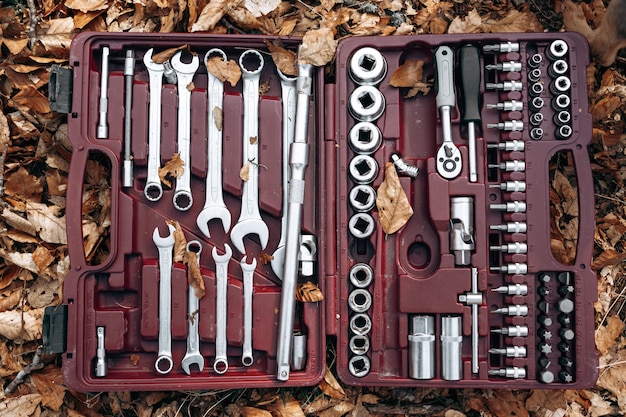 Set of wrenches in a box on forest ground