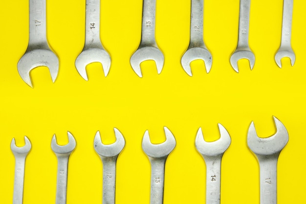 Set of wrenches on a yellow background.