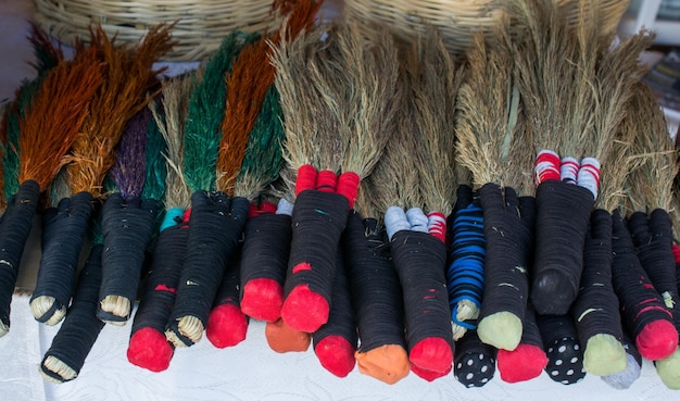 Set of yellow straw broom in bazaar