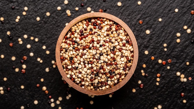 Sets quinoa seeds on a wooden bowl Healthy and diet superfood product Long banner format top view