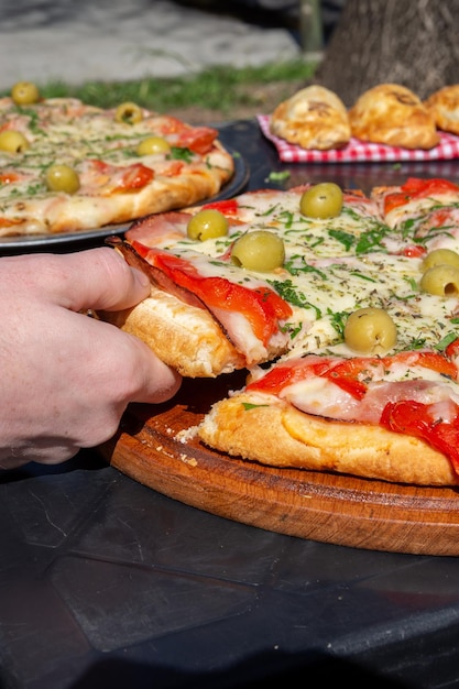 setting the table for an outdoor picnic to eat pizza