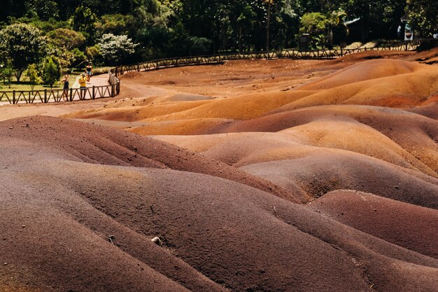 Seven colored earths in Mauritius, nature reserve, Chamarel. The green forest is behind us.Mauritius island