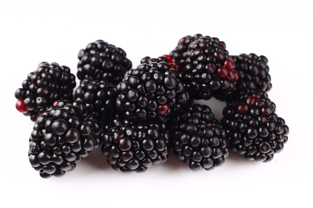 Several blackberries on a white surface