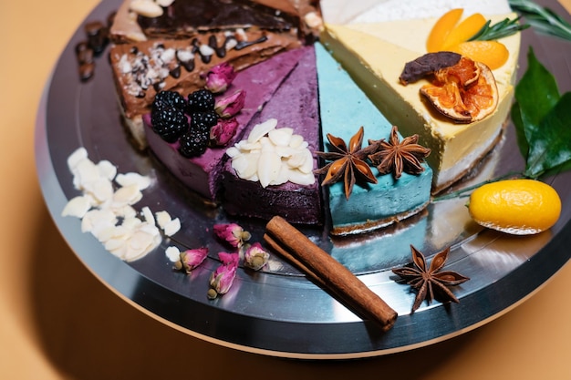 Several cakes are symmetrically laid out on a metal plate food\
delivery homemade baking close up